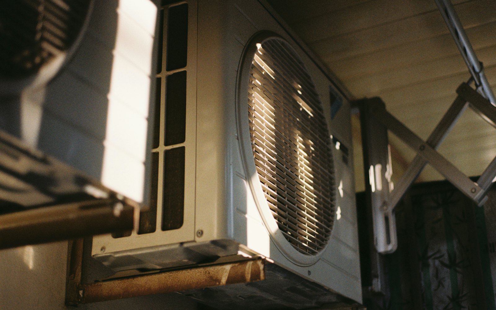 Close-up of an outdoor air conditioning unit in hard sunlight